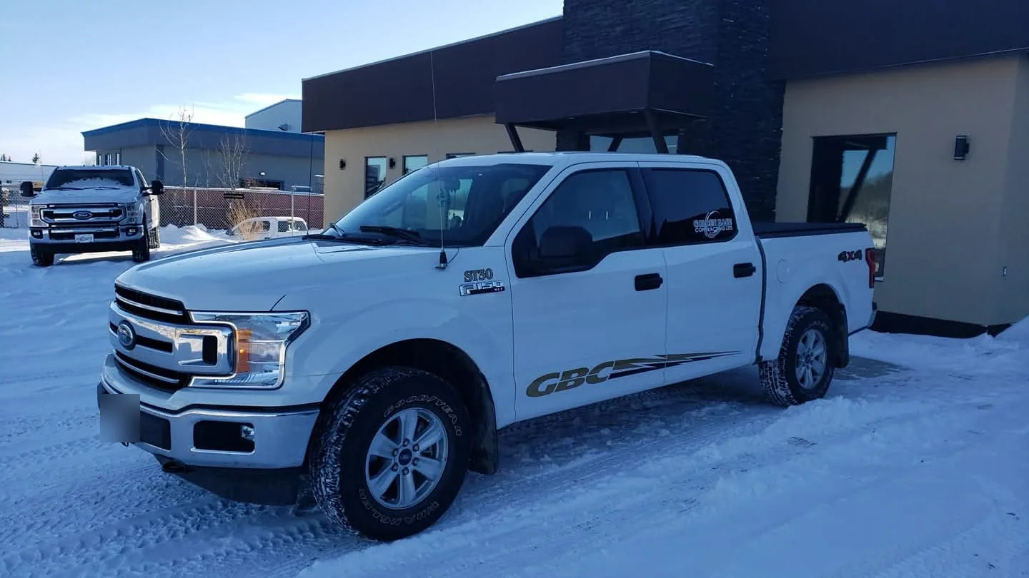 Crew cab pickup parked at the shop on a clear winter morning