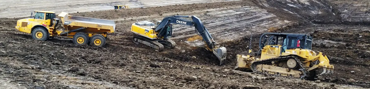 Excavator, dozer and rock truck working a cut